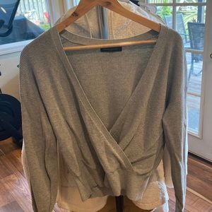 Fitted wrap style, gray sweater.